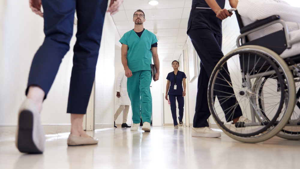 Busy Hospital Corridor With Medical Staff And Patients Busy Hospital Corridor With Medical Staff And Patients
