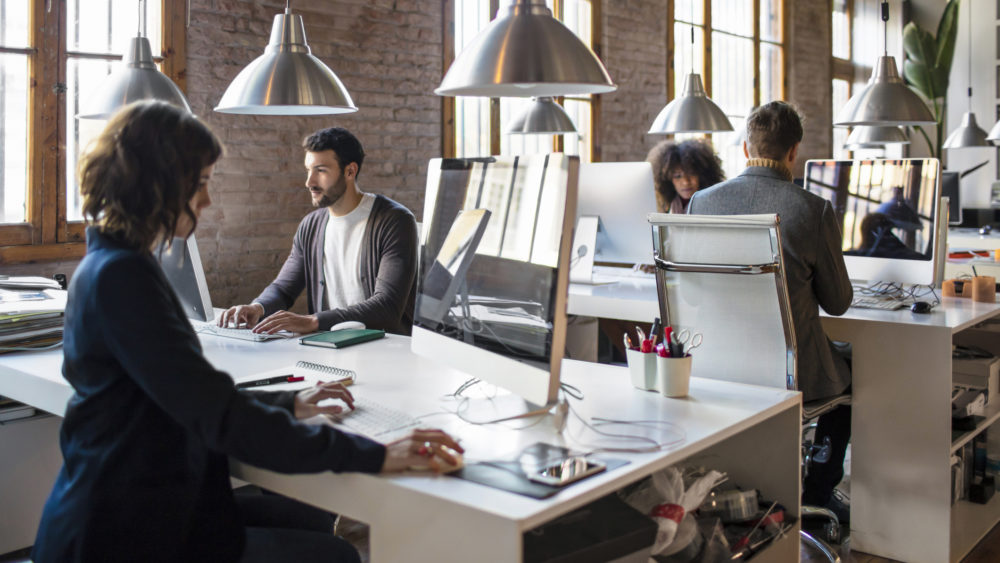 Open Setting Stock Photo an example of an open concept office that may struggle with speech privacy without a speech privacy system to manage excess noise